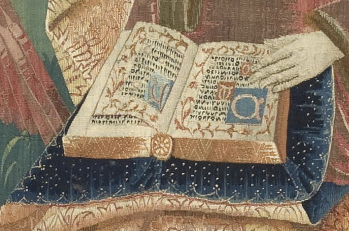 close up of gauffered gilded chemise binding manuscript open to page spread with illuminated initials, botanical floral borders, and simulated script